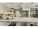 Bright kitchen area with a white marble counter, cabinets, and modern appliances at 1701 E Colter St # 488, Phoenix, AZ 85016