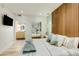 Modern bedroom features wood accent wall, pendant lights, and ensuite bathroom at 1701 E Colter St # 488, Phoenix, AZ 85016