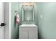Stylish powder room featuring a modern vanity, gold hardware, and a soft, calming color palette at 1920 N Cavalier Dr, Tempe, AZ 85288