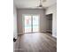 Open bedroom with wood-look flooring, a modern ceiling fan, and access to the pool at 1920 N Cavalier Dr, Tempe, AZ 85288