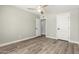 This bedroom features wood-look floors, a ceiling fan, and a convenient closet at 1920 N Cavalier Dr, Tempe, AZ 85288