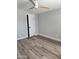 Neutral bedroom showcasing wood-look floors, white trim and a modern ceiling fan at 1920 N Cavalier Dr, Tempe, AZ 85288