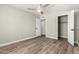 Spacious bedroom features wood-look floors, a ceiling fan, and a closet for storage at 1920 N Cavalier Dr, Tempe, AZ 85288