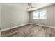 Bedroom with wood-look floors, a ceiling fan, and a window offering plenty of natural light at 1920 N Cavalier Dr, Tempe, AZ 85288
