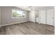 Bright bedroom with wood-look flooring, a large window, and ample closet space at 1920 N Cavalier Dr, Tempe, AZ 85288