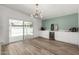 Elegant dining area featuring a stylish light fixture, wine fridge and sliding door access to outdoor patio at 1920 N Cavalier Dr, Tempe, AZ 85288