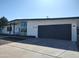 Contemporary home featuring a spacious garage, well-maintained lawn, and modern exterior lighting at 1920 N Cavalier Dr, Tempe, AZ 85288