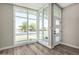 Light-filled foyer with large windows, stylish front door, and attractive wood-look vinyl plank flooring at 1920 N Cavalier Dr, Tempe, AZ 85288