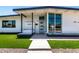 Charming modern home with green lawn, crisp white paint, elegant dark trim, and minimalist desert landscaping at 1920 N Cavalier Dr, Tempe, AZ 85288