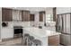 Modern kitchen featuring a large island with quartz countertop, stainless steel appliances, and stylish wood cabinets at 1920 N Cavalier Dr, Tempe, AZ 85288