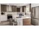 Beautiful kitchen featuring stainless steel appliances, herringbone backsplash, and quartz countertop island at 1920 N Cavalier Dr, Tempe, AZ 85288