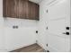 Laundry room featuring wood cabinets above a washing machine hookup and a nearby door at 1920 N Cavalier Dr, Tempe, AZ 85288