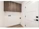 Functional laundry room featuring storage cabinets and connection points for washer and dryer at 1920 N Cavalier Dr, Tempe, AZ 85288