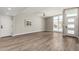 Spacious living room featuring wood-look floors, neutral walls, and large windows allowing ample natural light at 1920 N Cavalier Dr, Tempe, AZ 85288