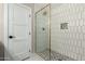 Modern shower with sleek tiles, glass door, and recessed niche at 1920 N Cavalier Dr, Tempe, AZ 85288
