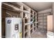 Spacious utility room with ample shelving and a water heater, providing convenient storage solutions at 1920 N Cavalier Dr, Tempe, AZ 85288