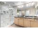 Luxurious bathroom with glass-enclosed shower, double vanity, and elegant lighting fixtures at 19700 N 76Th St # 1151, Scottsdale, AZ 85255