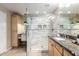 Modern bathroom with glass walk-in shower, updated fixtures, and natural wood vanity at 19700 N 76Th St # 1151, Scottsdale, AZ 85255