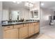Bathroom featuring a double sink vanity with granite counters and decorative mirrors at 19700 N 76Th St # 1151, Scottsdale, AZ 85255