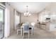 Inviting dining room with natural light, stylish chandelier, and view of the modern kitchen at 19700 N 76Th St # 1151, Scottsdale, AZ 85255