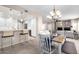 Open-concept living and dining area with modern kitchen featuring a wine cooler and a breakfast bar at 19700 N 76Th St # 1151, Scottsdale, AZ 85255