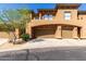 Tuscan-style home with brown garage doors, stucco finish, and well manicured landscaping at 19700 N 76Th St # 1151, Scottsdale, AZ 85255