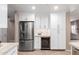 Modern kitchen with stainless steel refrigerator, wine cooler, and white cabinetry at 19700 N 76Th St # 1151, Scottsdale, AZ 85255