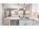Bright, open kitchen featuring quartz countertops, stainless steel appliances, and island with pendant lights at 19700 N 76Th St # 1151, Scottsdale, AZ 85255