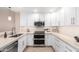 Bright, all-white kitchen featuring modern appliances, stone countertops, and ample cabinet space at 19700 N 76Th St # 1151, Scottsdale, AZ 85255