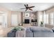 Cozy living room featuring a fireplace, ceiling fan, and sliding glass doors to the patio at 19700 N 76Th St # 1151, Scottsdale, AZ 85255