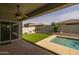 Private backyard with a covered patio, swimming pool, and lush landscaping for outdoor enjoyment at 20233 E Maya Rd, Queen Creek, AZ 85142