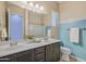 Bathroom featuring dual sinks, large vanity, and painted accent wall at 20233 E Maya Rd, Queen Creek, AZ 85142