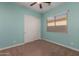 This bedroom features neutral paint, ceiling fan, closet and a window with bright, natural light at 20233 E Maya Rd, Queen Creek, AZ 85142