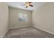 Bedroom featuring neutral paint, ceiling fan and a window with bright, natural light at 20233 E Maya Rd, Queen Creek, AZ 85142