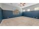 Bedroom boasts two-tone walls, neutral carpeting, and a ceiling fan for added comfort at 20233 E Maya Rd, Queen Creek, AZ 85142