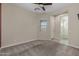 This bedroom features neutral paint, ceiling fan and a window with bright, natural light at 20233 E Maya Rd, Queen Creek, AZ 85142