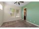 Bedroom featuring neutral paint, ceiling fan, and a window with bright, natural light at 20233 E Maya Rd, Queen Creek, AZ 85142