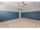 Cozy bedroom with neutral carpet, two-tone paint scheme, and a modern ceiling fan at 20233 E Maya Rd, Queen Creek, AZ 85142
