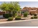 Well-kept home with mature trees, shrubbery, and a brick driveway adding to its curb appeal at 20233 E Maya Rd, Queen Creek, AZ 85142