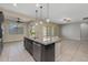 The kitchen includes granite countertops, island, stainless steel dishwasher and tile flooring at 20233 E Maya Rd, Queen Creek, AZ 85142