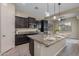 Well-equipped kitchen with granite island, stainless appliances, and stylish pendant lighting at 20233 E Maya Rd, Queen Creek, AZ 85142