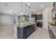 Stylish kitchen with a center island, stainless steel appliances, and ample cabinet space at 20233 E Maya Rd, Queen Creek, AZ 85142