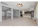 Open-concept living room with tile flooring, a ceiling fan, and seamless flow to the kitchen at 20233 E Maya Rd, Queen Creek, AZ 85142
