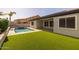 Backyard features pool with artificial turf and covered patio area for outdoor enjoyment at 20233 E Maya Rd, Queen Creek, AZ 85142