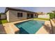 Backyard featuring refreshing pool, lush artificial turf, and a well-maintained exterior at 20233 E Maya Rd, Queen Creek, AZ 85142
