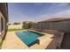 Backyard showcasing a refreshing pool surrounded by artificial turf and landscaping at 20233 E Maya Rd, Queen Creek, AZ 85142