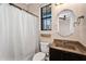 This bathroom features a toilet, vanity with granite countertop and sink, and a shower behind a curtain at 2090 S Dorsey Ln # 1037, Tempe, AZ 85282
