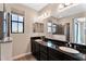 Modern bathroom featuring dual sinks, granite countertops, and a glass-enclosed shower at 2090 S Dorsey Ln # 1037, Tempe, AZ 85282