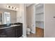 This bathroom features a single vanity with a dark wood finish and granite countertop and a toilet near the closet at 2090 S Dorsey Ln # 1037, Tempe, AZ 85282
