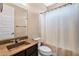 This bathroom features a vanity with granite countertop and sink and a shower behind a curtain at 2090 S Dorsey Ln # 1037, Tempe, AZ 85282
